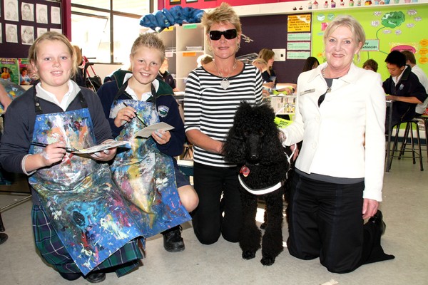 The Great Bayleys Art Competition organiser Anne Rattray, right, joins budding artists and Wakatipu High School students Hanna Anstiss, left, and Lucas Cameron, second from left, to learn first hand about the experiences of guide dog handler Jenny McBride